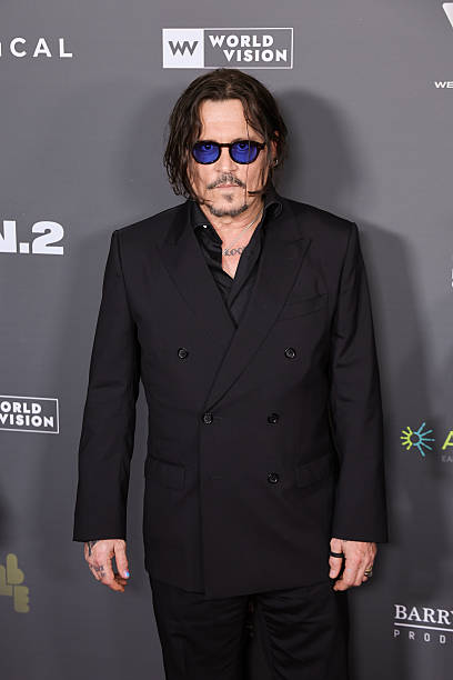 Johnny Depp’s All-Black Double-Breasted Suit Look Steals the Spotlight at the “Modi: Three Days On The Wing Of Madness” Premiere
